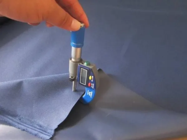 Benshine operator checking soft material thickness with a gauge